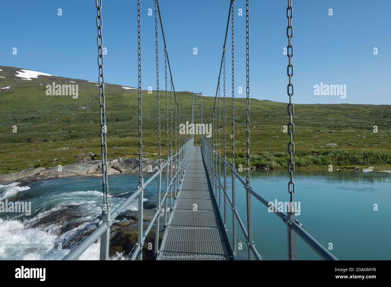 Hanging bridge Miellädno river along Padjelantaleden Trail, Padjelanta national park, Lapland, Sweden Stock Photo