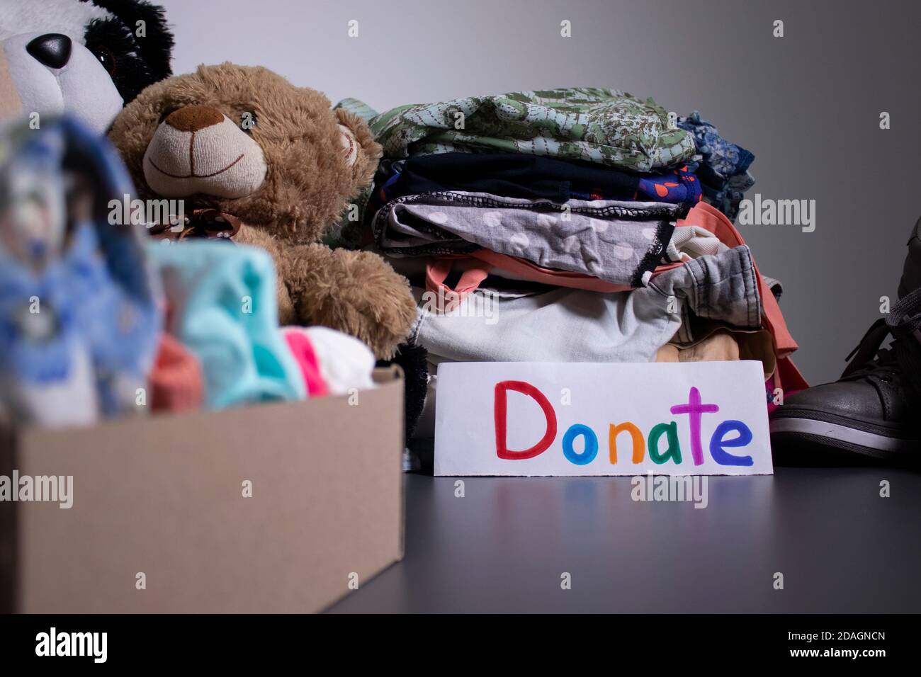 'Donate' sign handwritten with multicoloured letters. A box with