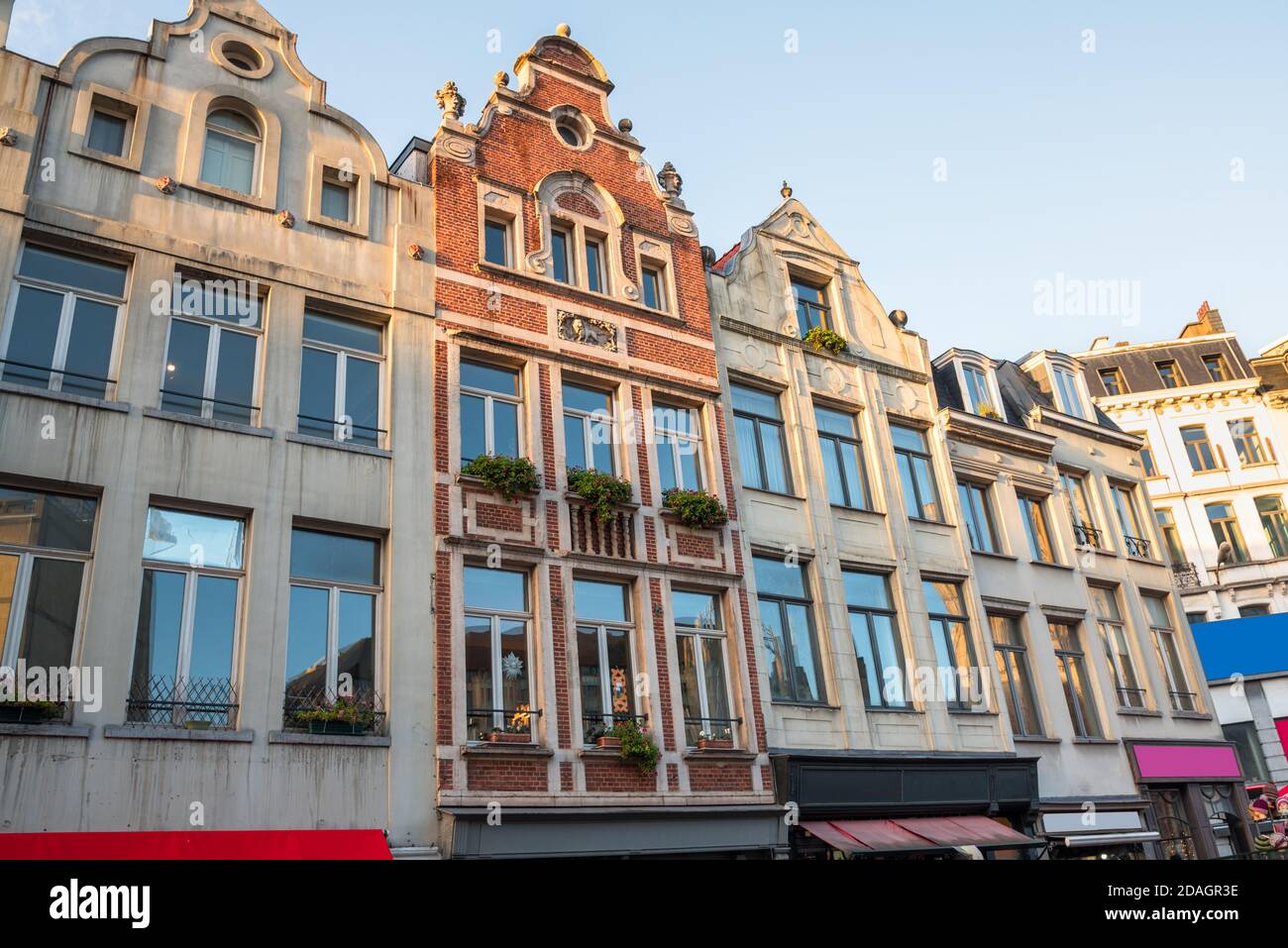 Historic architecture with colourful shopfronts in central Brussels, Belgium, at sunset in winter Stock Photo