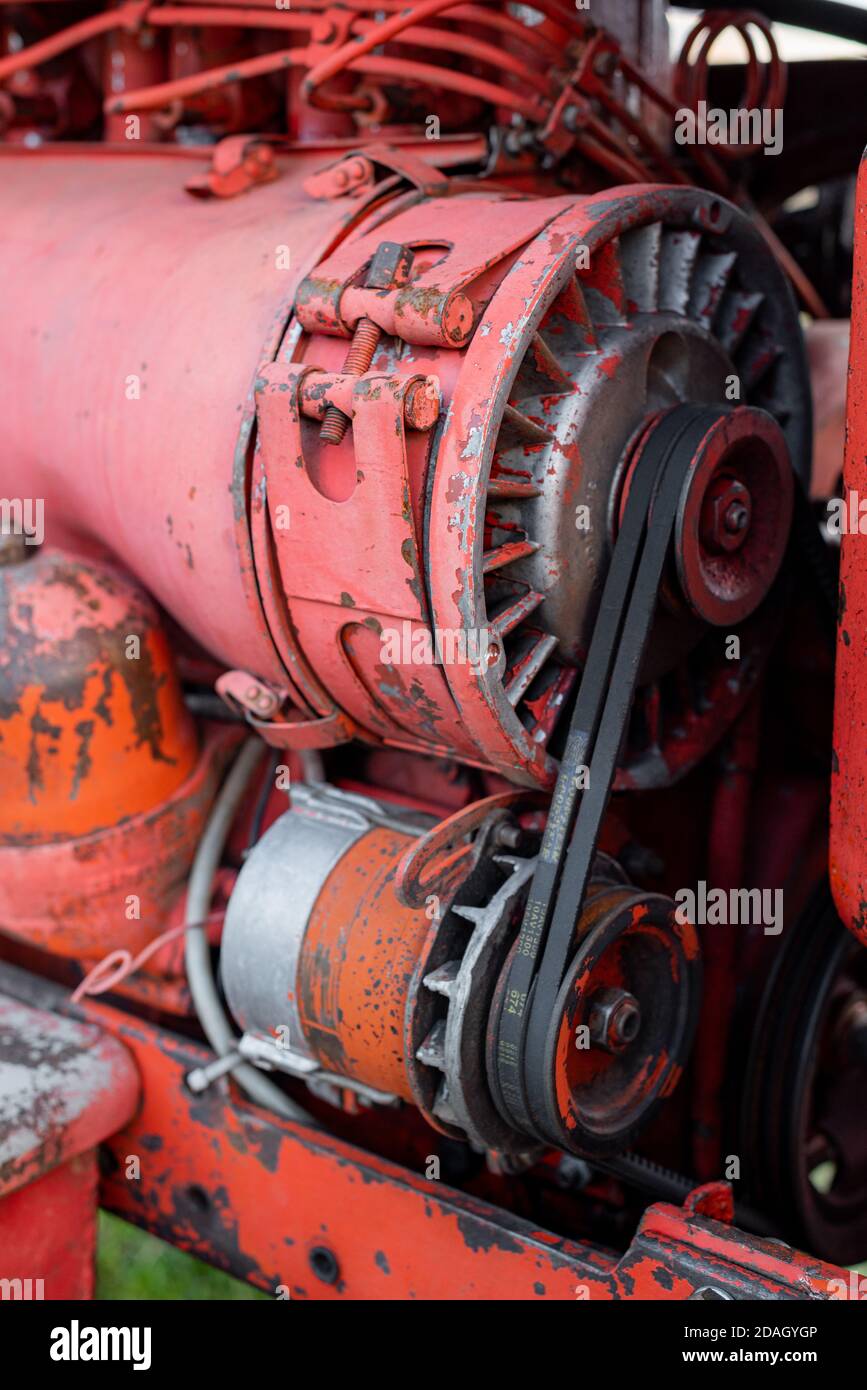 Closeup of four cylinder diesel tractor engine with visible belt rusty ...