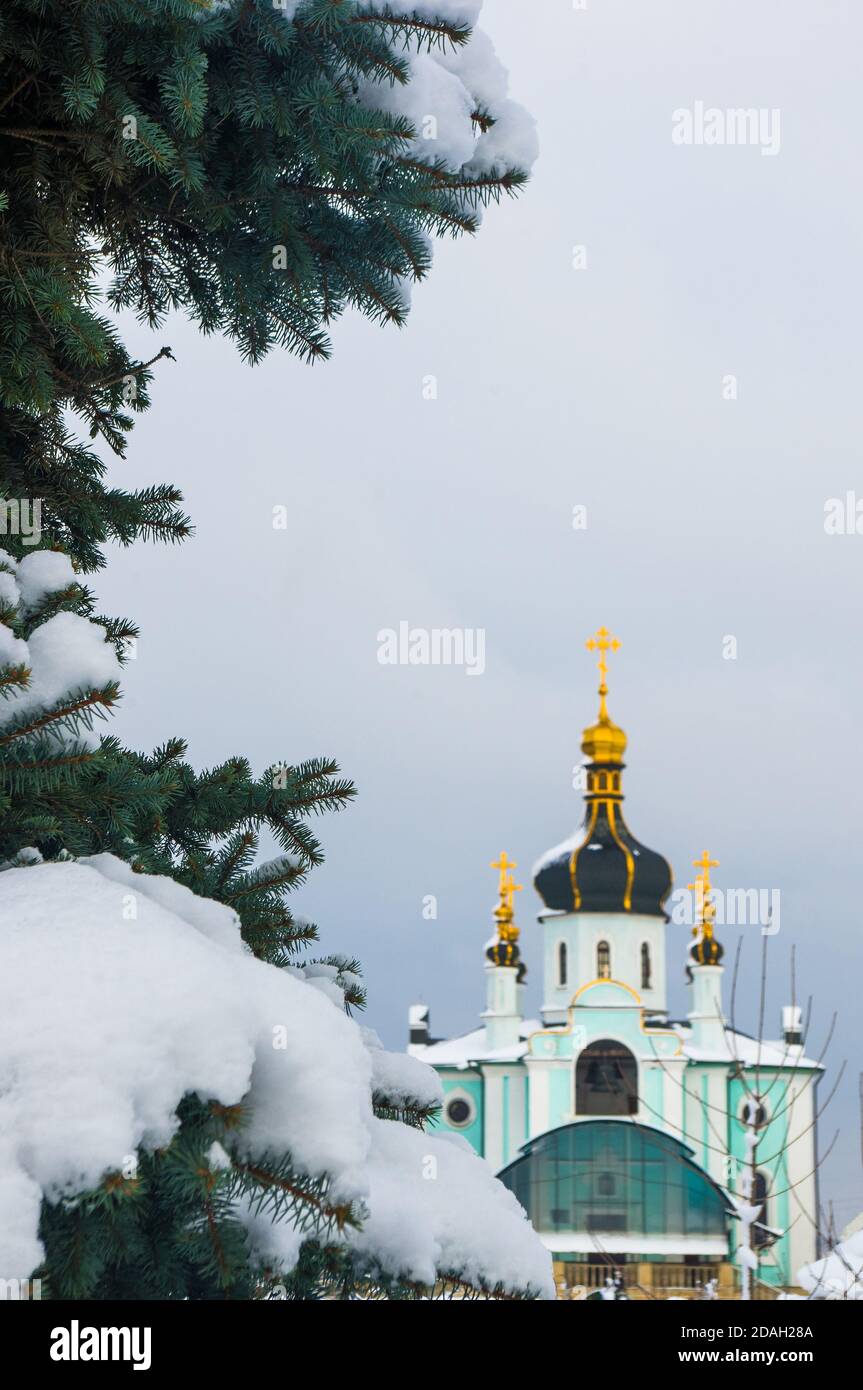 Winter landscape - Orthodox church in the snow among fir-trees on a cold frosty day Stock Photo