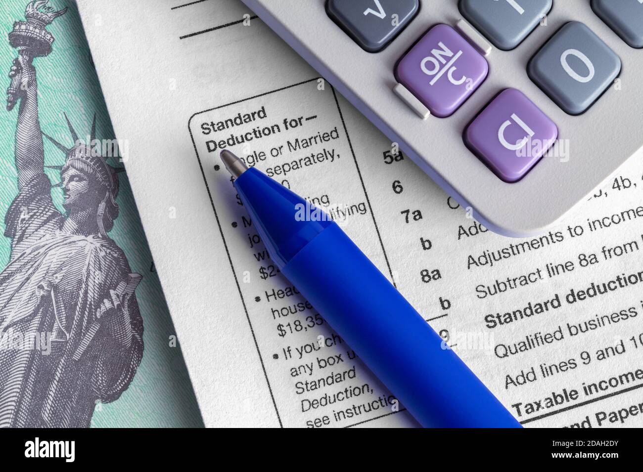 Tax Form 1040 with Refund Check and Claculator. Stock Photo