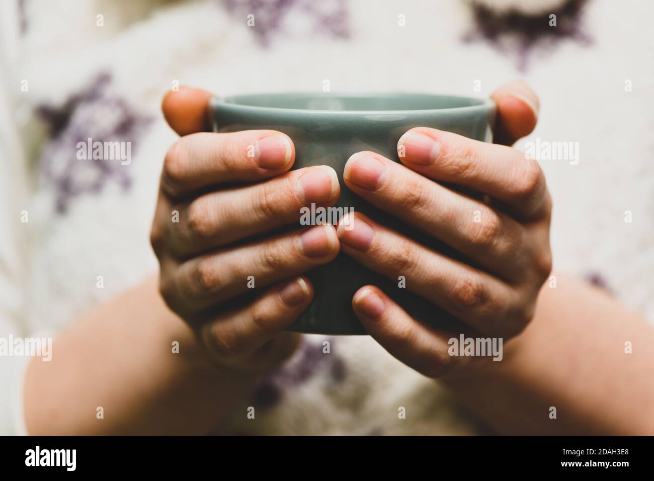 Young wooman drinking hot cocoa or coffee. Autumn or winter moody weekend, New Year and Christmas background. Lazy day, quarantine, stay home, cosy sc Stock Photo