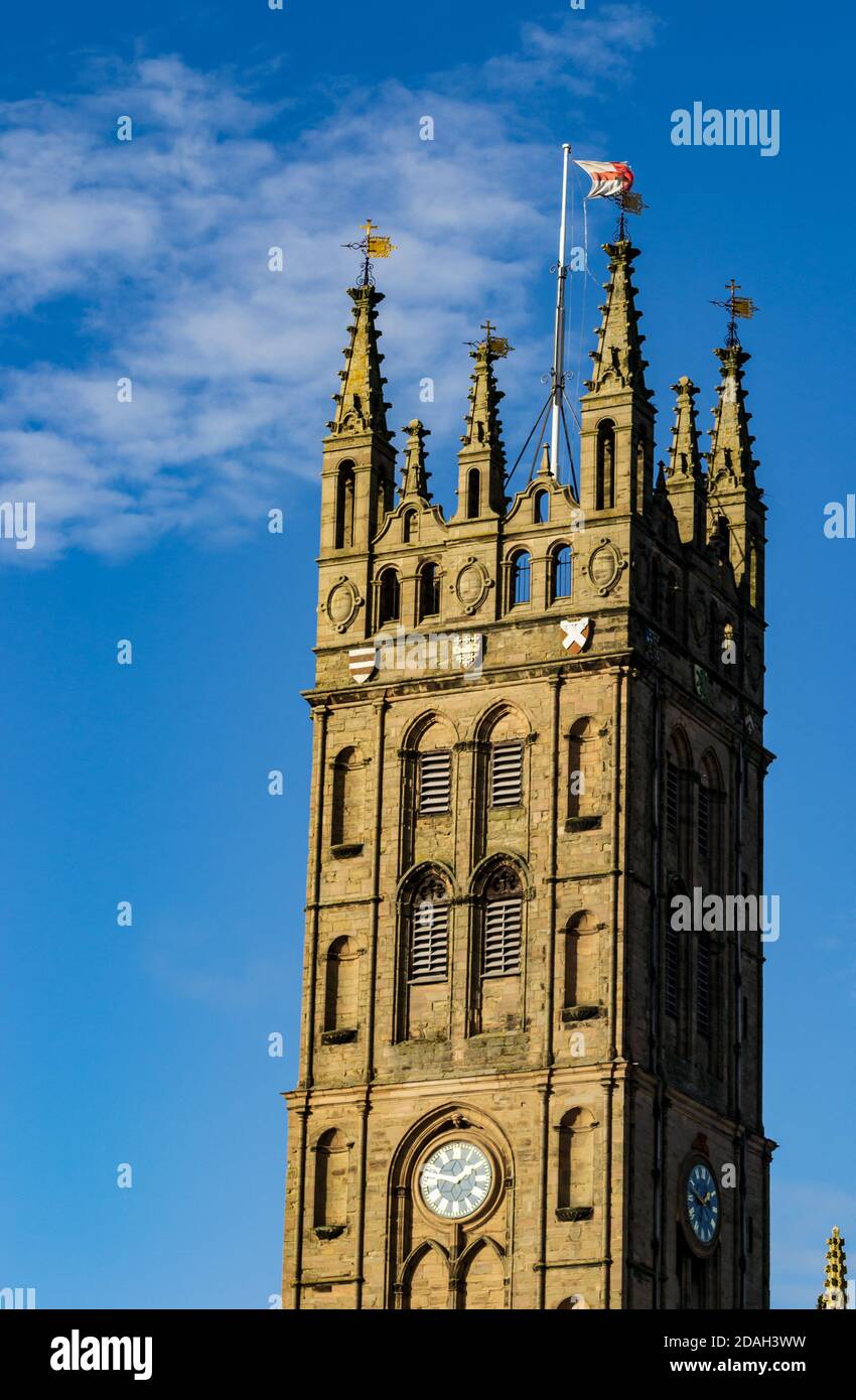 Collegiate Church of St Mary, Warwick. England flag upon a pole waving in the fresh blue sky. Warwickshire, UK. Stock Photo