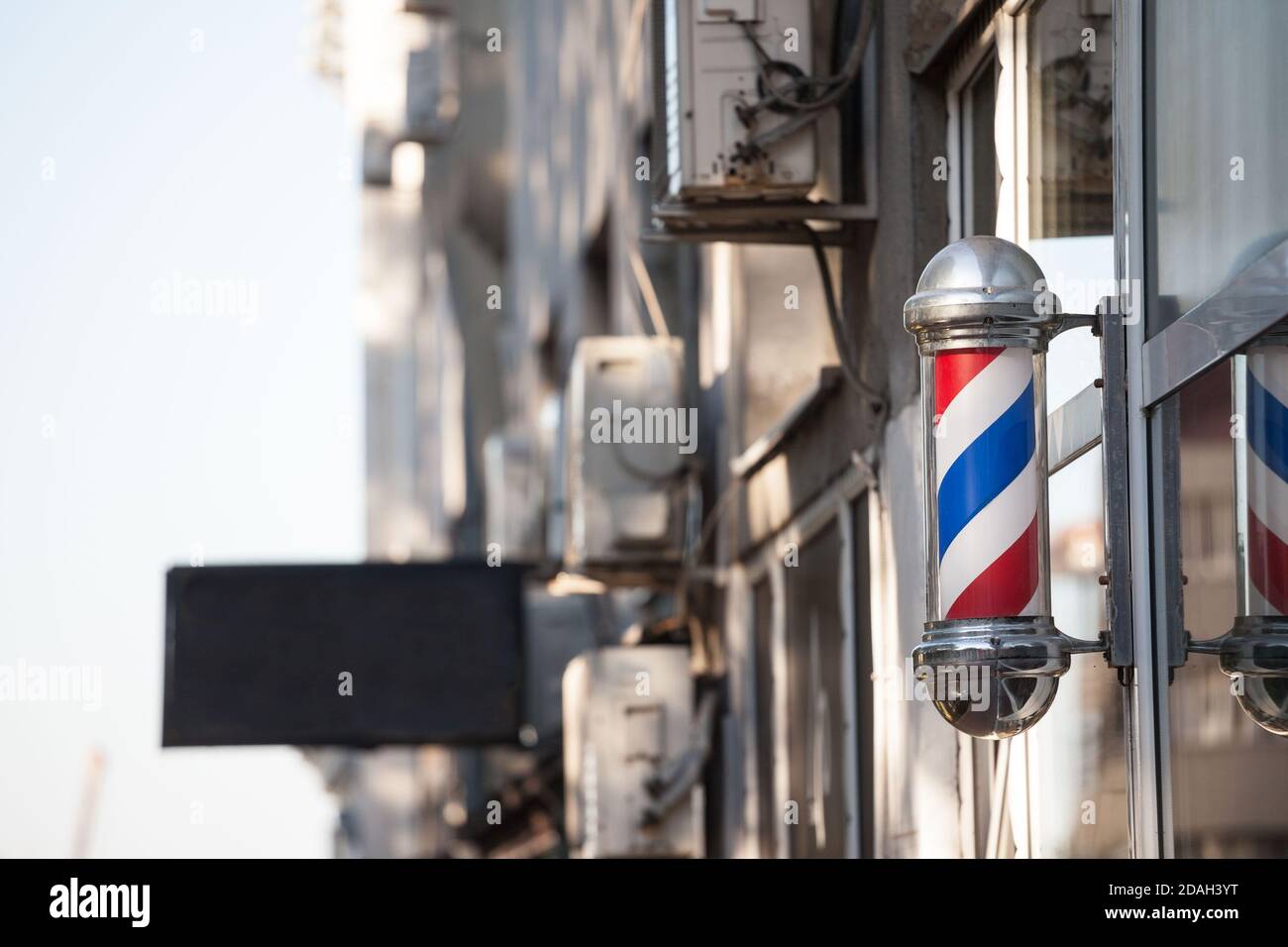 Typical American Barbers Pole Seen In Front Of A Barber Shop This Pole Is A Vintage Sign Indicating The Presence Of A Male Hairdresser Salon Pictur Stock Photo Alamy