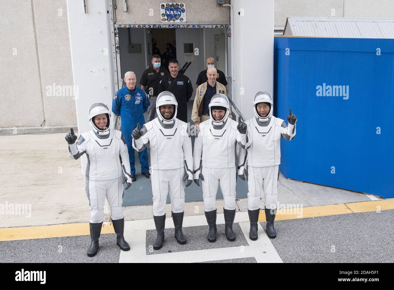 Kennedy Space Center, Florida, USA. 12th Nov 2020. NASA astronauts Shannon Walker, left, Victor Glover, second from left, Mike Hopkins, second from right, and Japan Aerospace Exploration Agency (JAXA) astronaut Soichi Noguchi, right, wearing SpaceX spacesuits, stop to pose for a picture as walk out of the Neil A. Armstrong Operations and Checkout Building to depart for Launch Complex 39A during a dress rehearsal prior to the Crew-1 mission launch, on November 12, 2020, at NASA's Kennedy Space Center in Florida. Credit: UPI/Alamy Live News Stock Photo