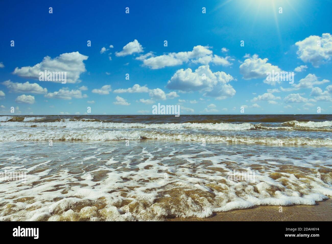 Scenic cloudscape with sea waves and horizon over water. Extreme long shot. Stock Photo