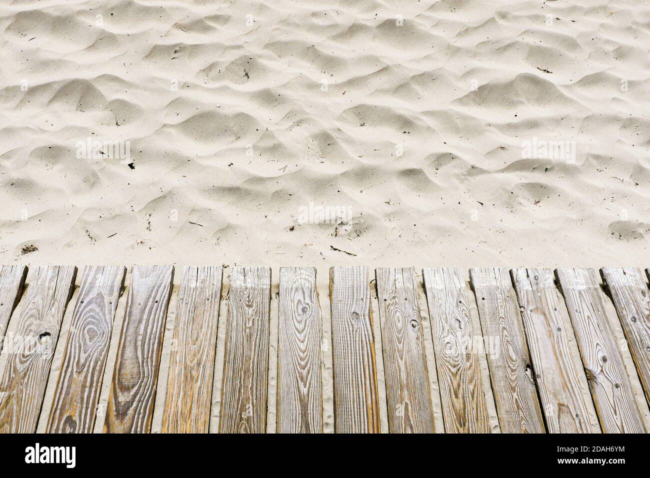 Wooden planked walkway on white beach sand. High angle view. Stock Photo