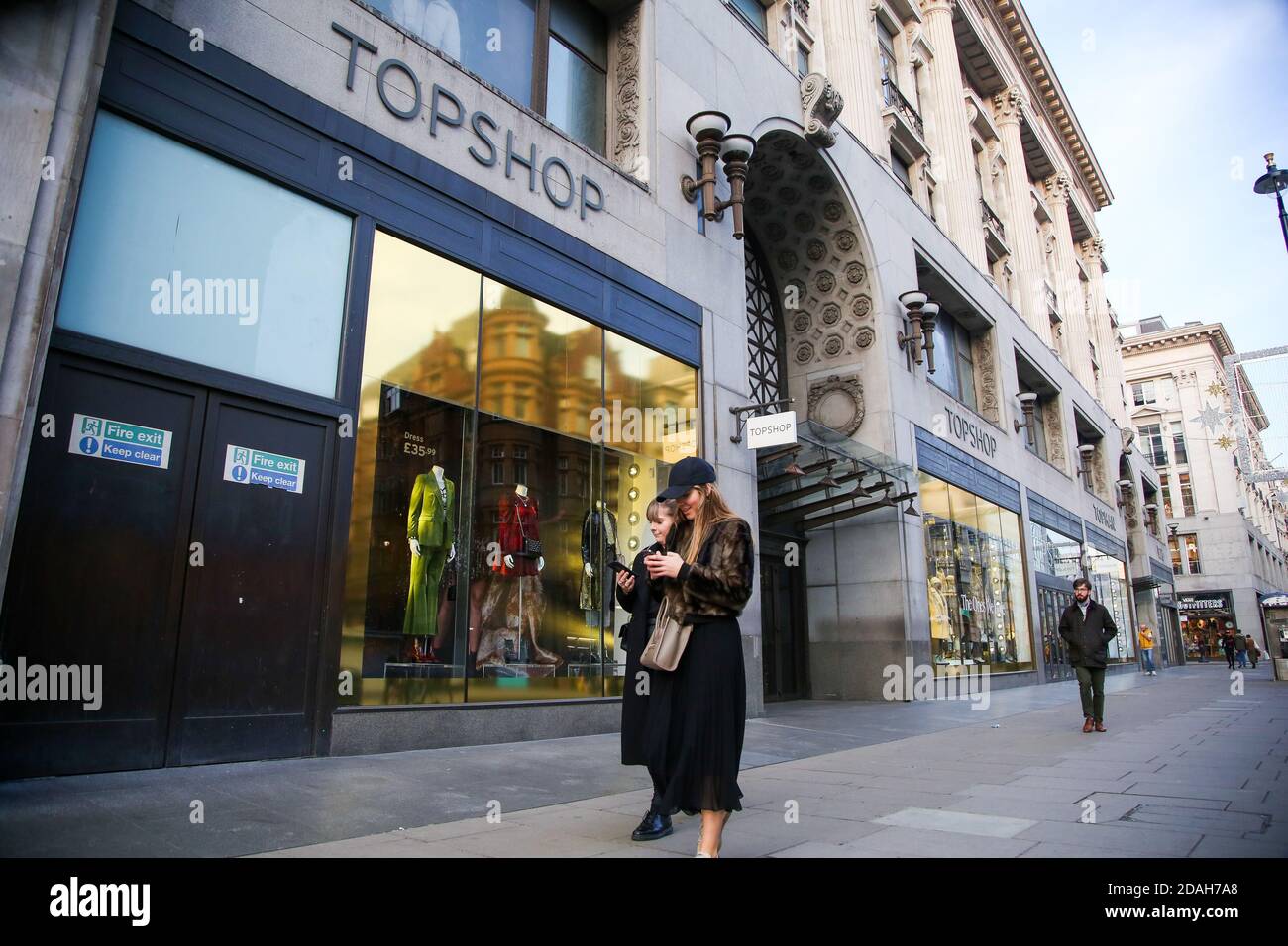 Women using their phones while standing next to a branch of TopShop on Regent  Street. (Photo by Dinendra Haria / SOPA Images/Sipa USA Stock Photo - Alamy