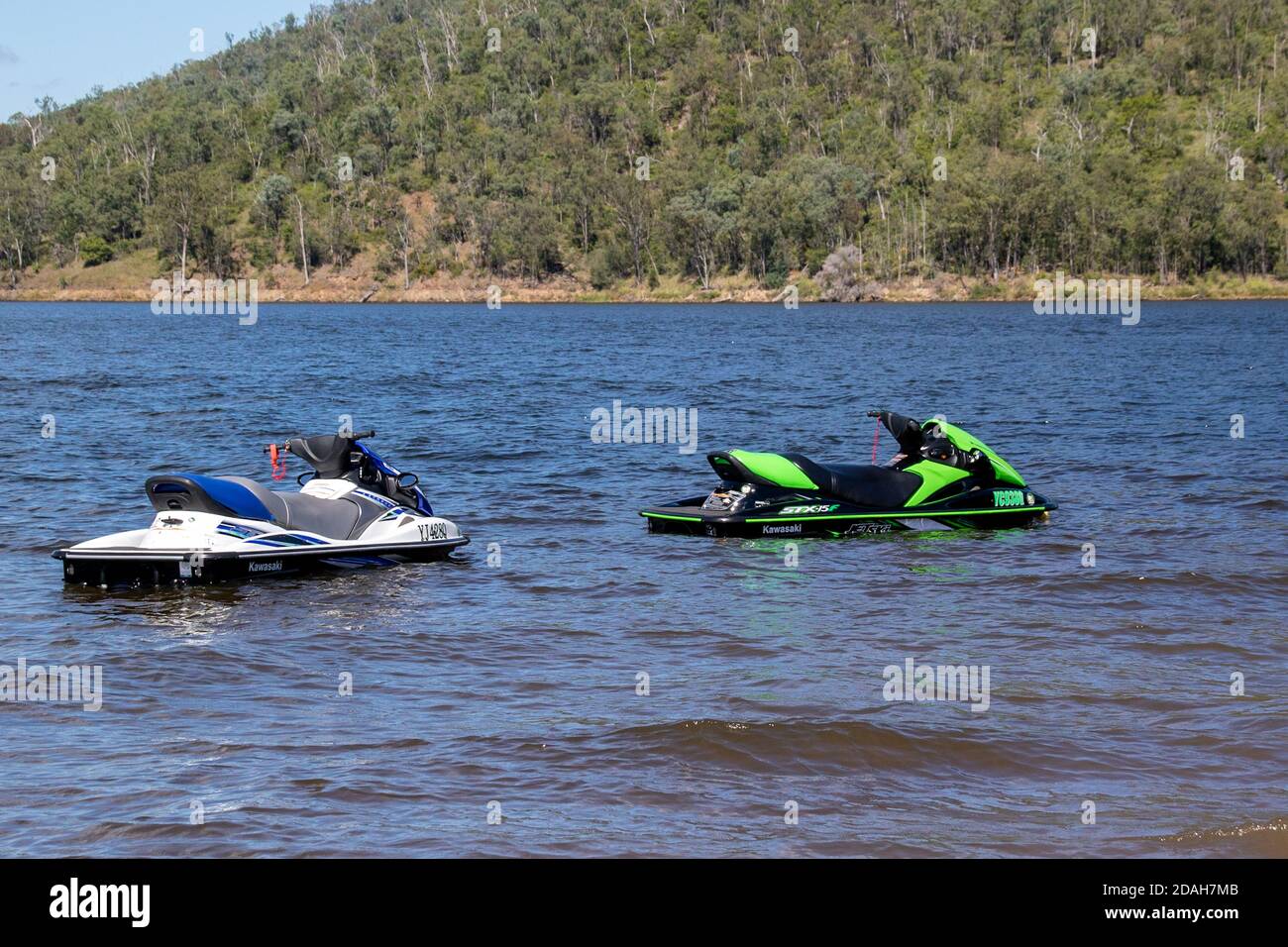Two jet skis parked up on a lake with no riders Stock Photo