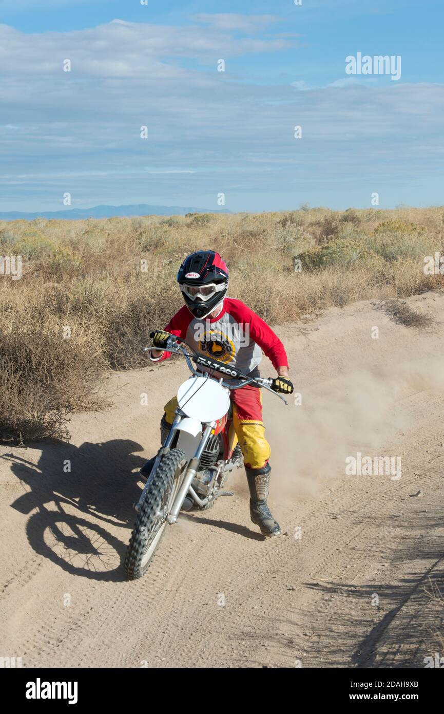 Cyclist driving a vintage Bultaco dirt bike Stock Photo