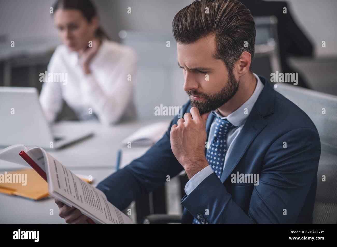 Business man attentively examining documents in office Stock Photo