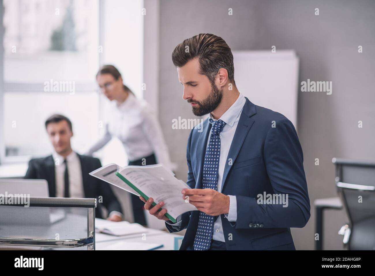 Serious business man in profile reading document Stock Photo
