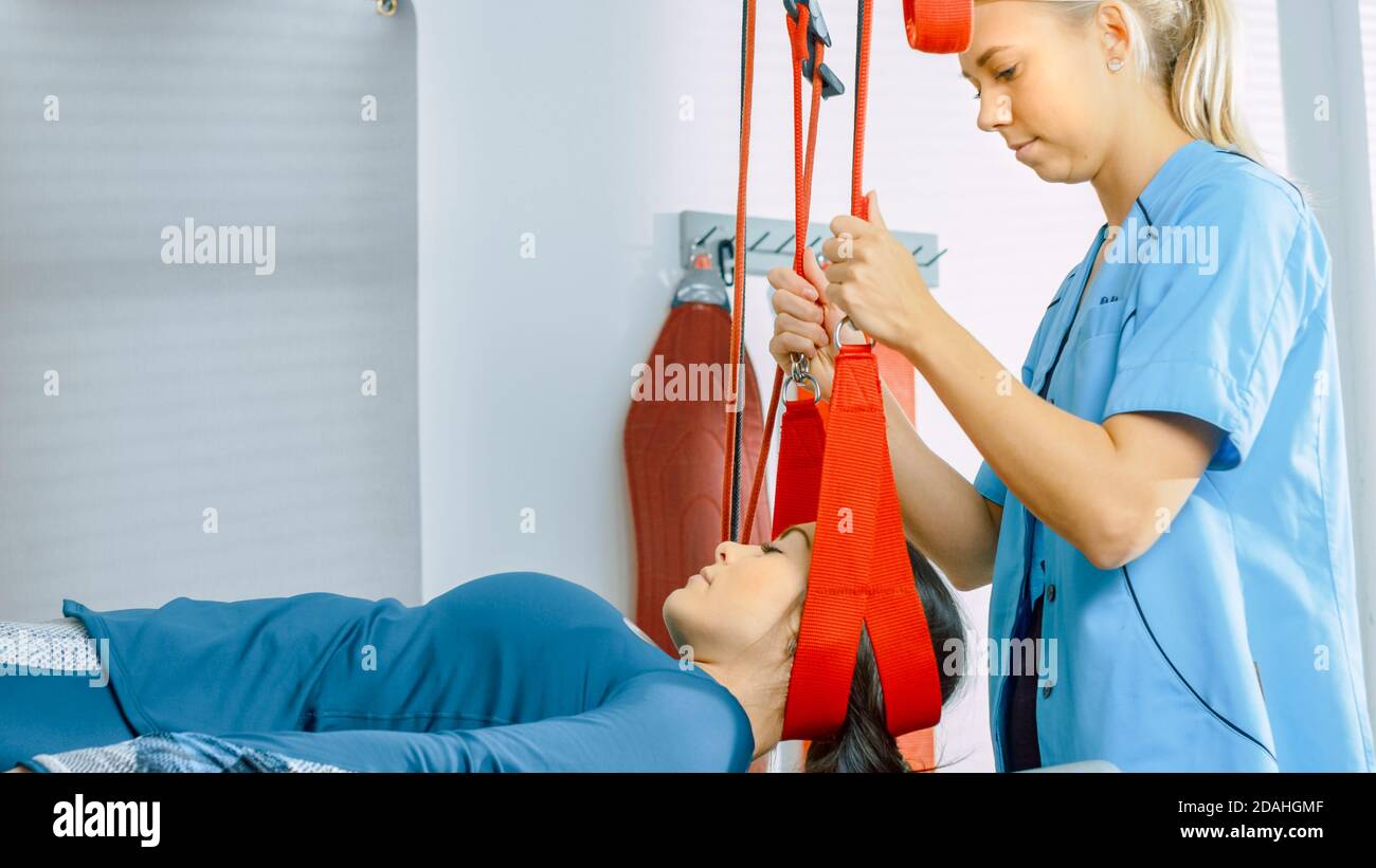 Physiotherapist Assists Female Patient with Trauma, Undergoing