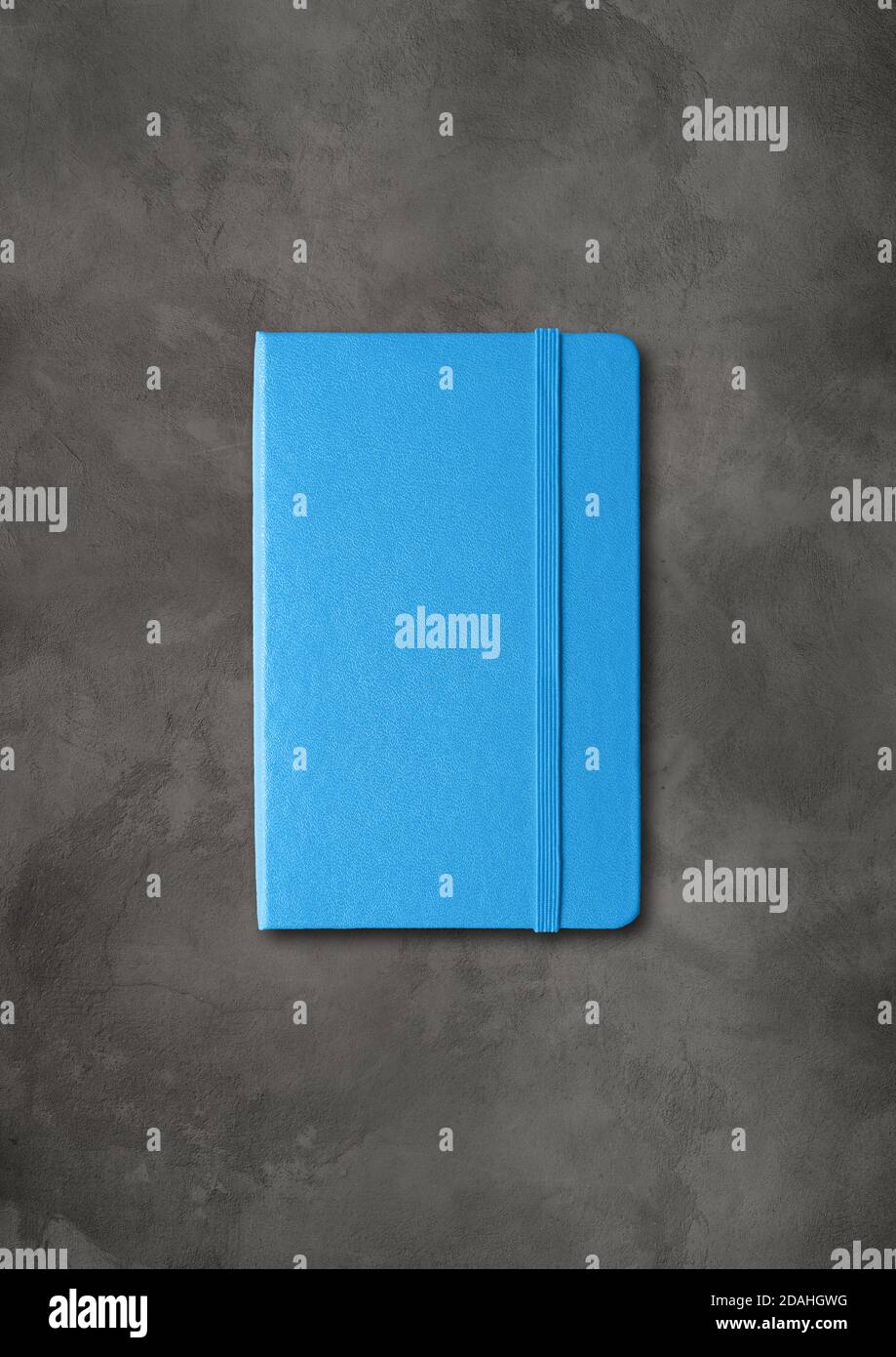 Blue closed notebook mockup isolated on dark concrete background Stock Photo