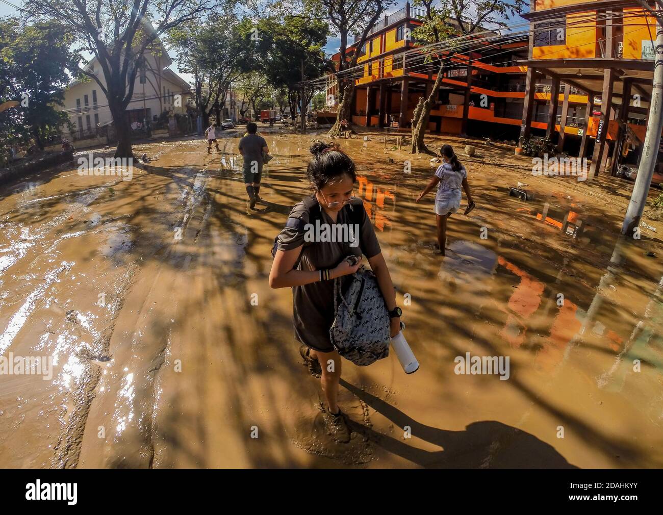 Manila, Philippines. 13th Nov, 2020. Residents walk on a muddy road after the flood brought by Typhoon Vamco in Manila, the Philippines, Nov. 13, 2020. The Philippine government said on Friday that Typhoon Vamco, which has caused devastating floods and landslides in the main island of Luzon, has killed at least 14 people, officials said. Credit: Rouelle Umali/Xinhua/Alamy Live News Stock Photo