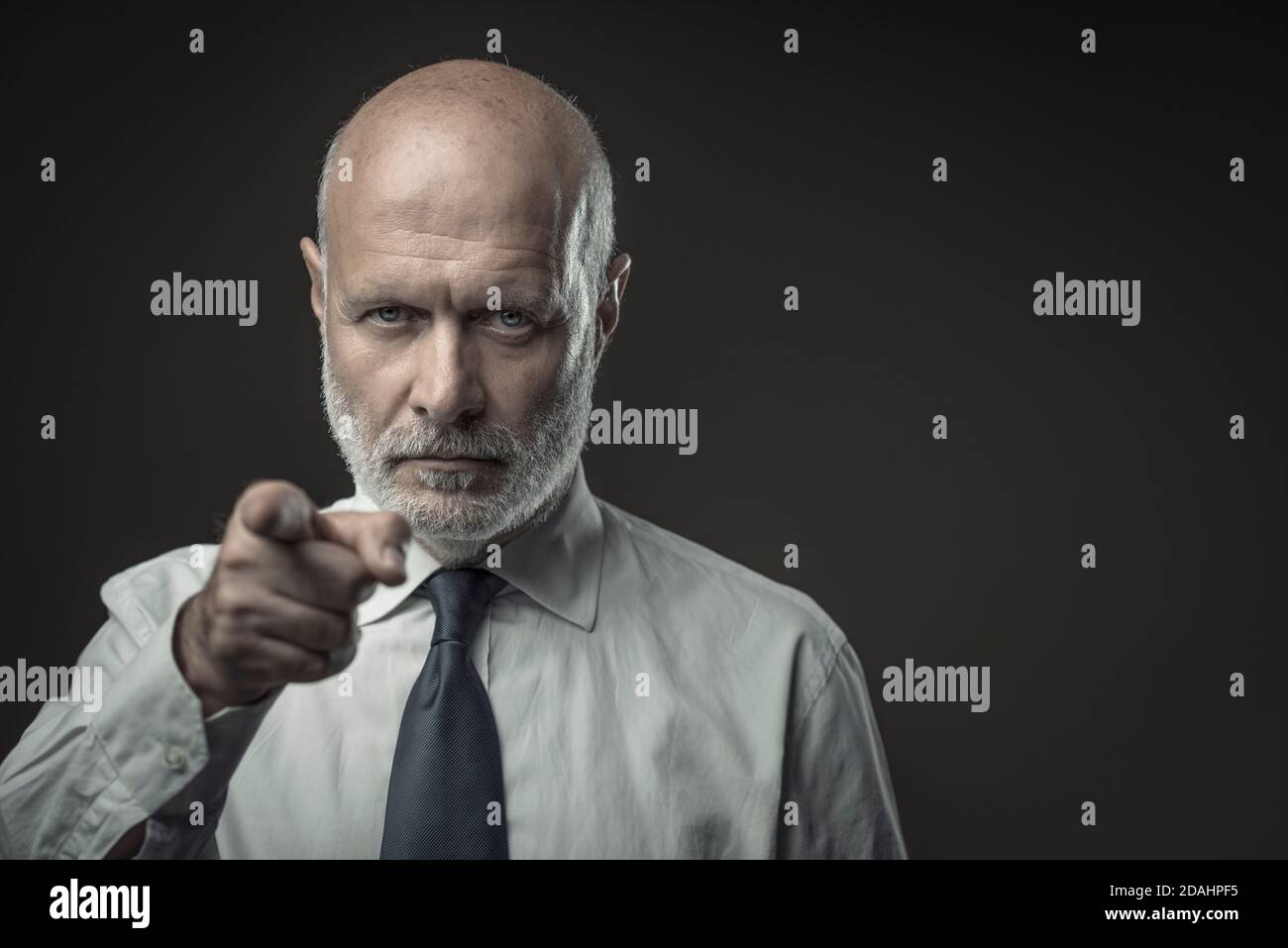 Corporate business executive pointing at camera, selection and ...