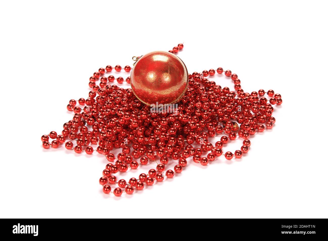 Closeup of a Christmas red pearl beaded chain with a red ball isolated on a white background Stock Photo