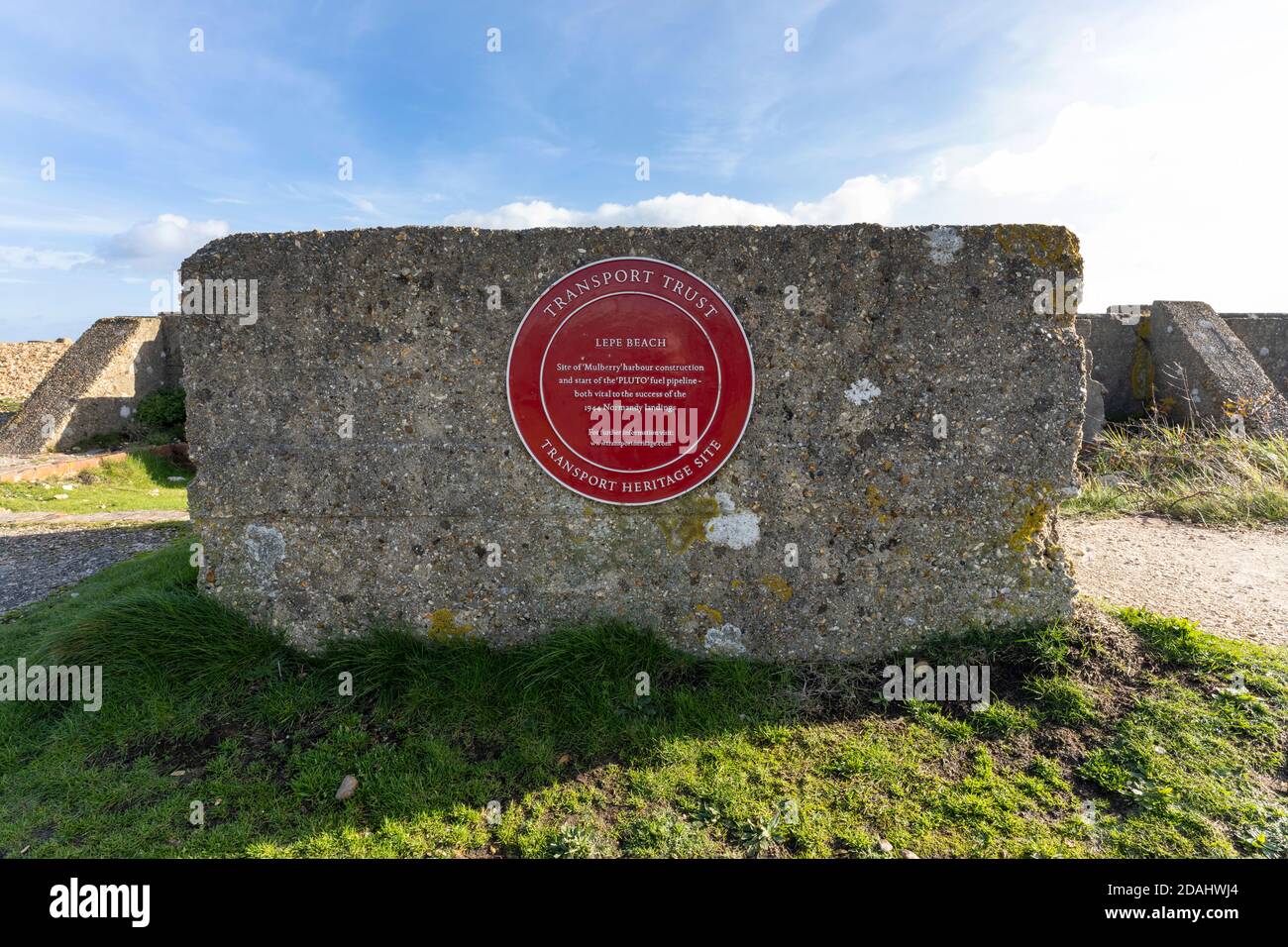 Red Heritage Plaque at Lepe Beach, New Forest, Hampshire, England, UK - site of 'Mulberry' harbour construction and start of 'Pluto' fuel pipeline. Stock Photo