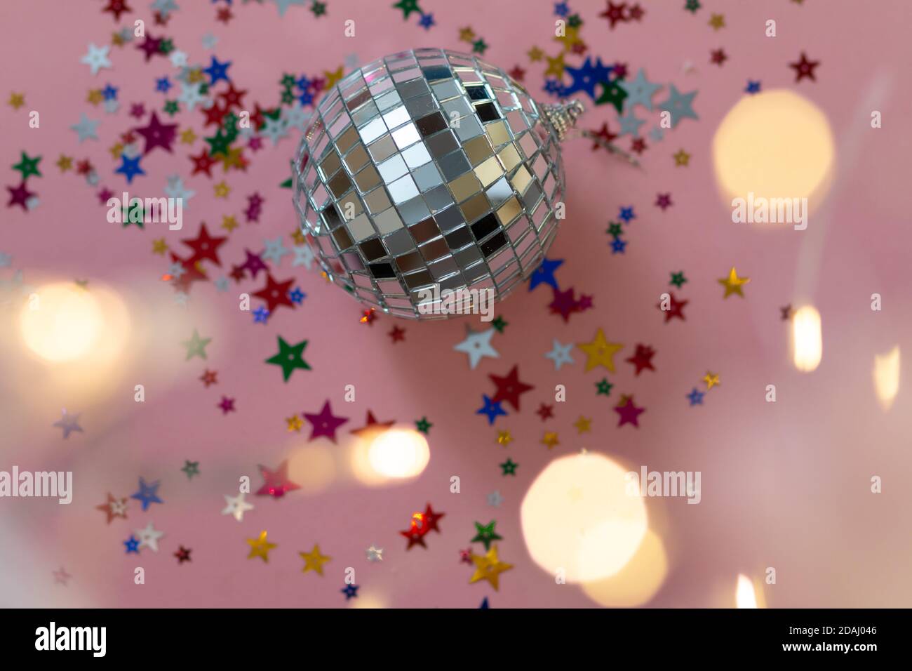 Sparkling pink disco ball on an abstract swirl background Stock Photo -  Alamy