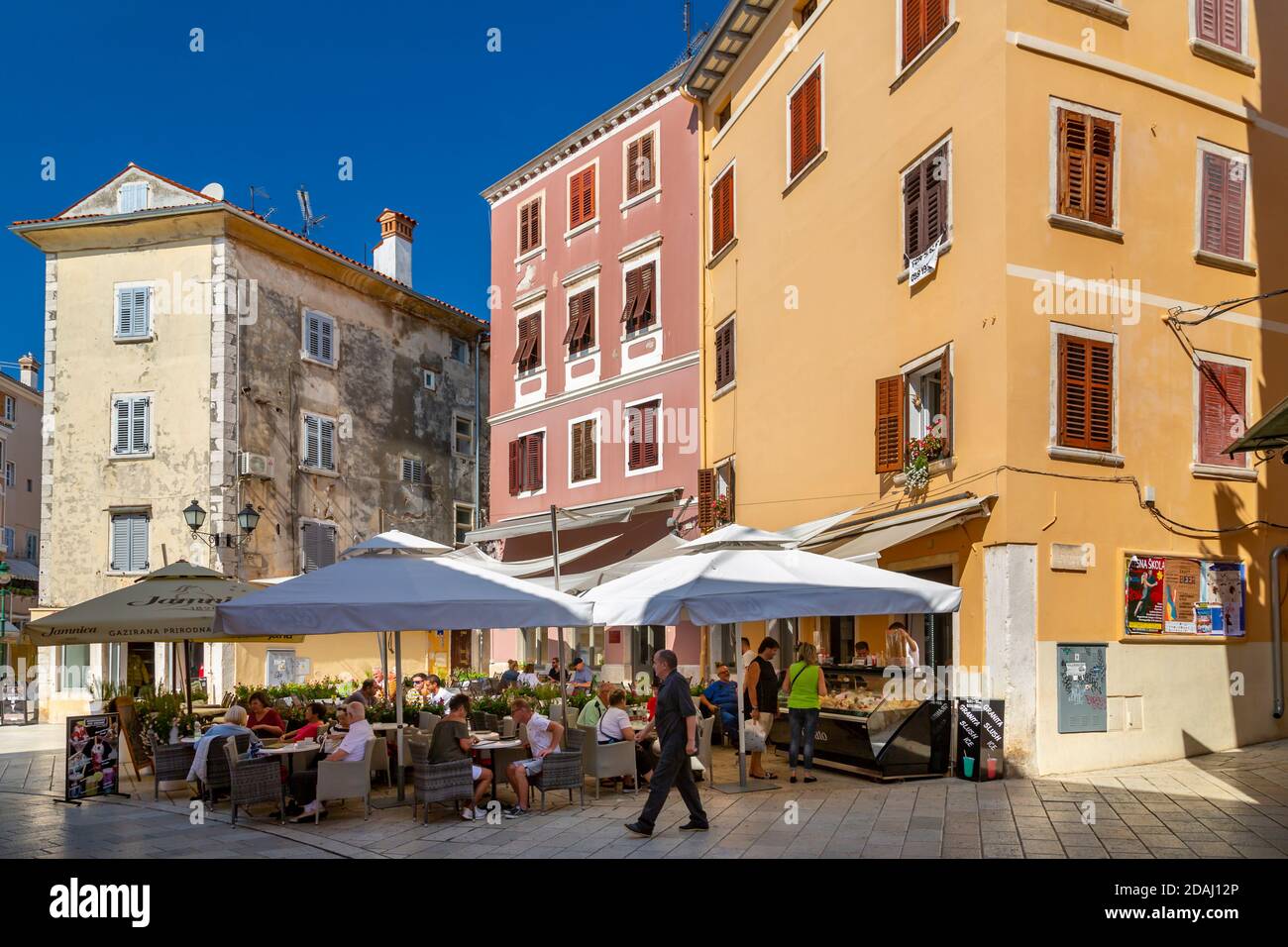 View of cafe and people in colourful old town, Rovinj, Istria, Croatia, Adriatic, Europe Stock Photo