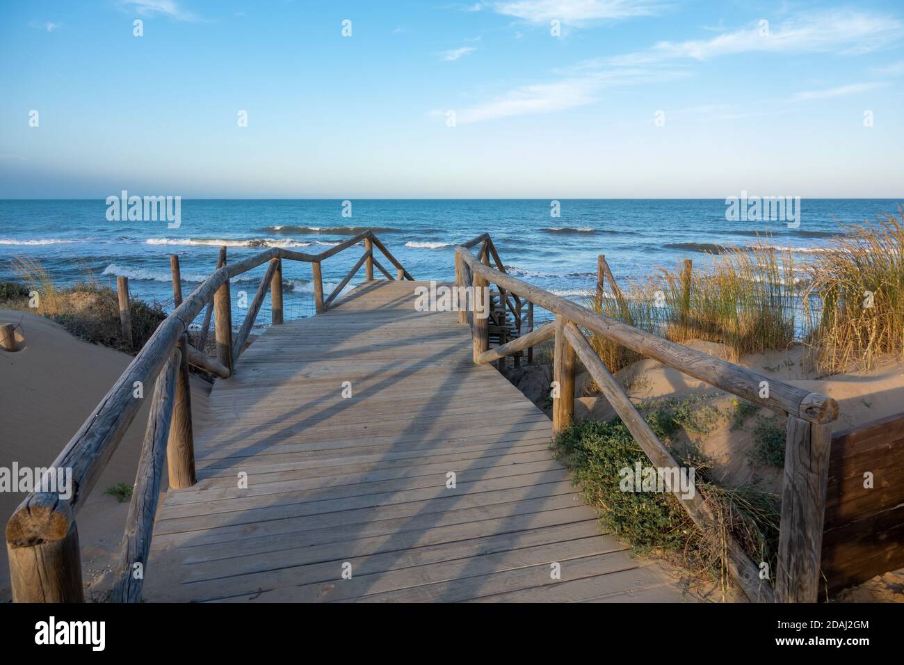 Broadwalk to a sand beach at  Mediterranean ocean in Spain Stock Photo