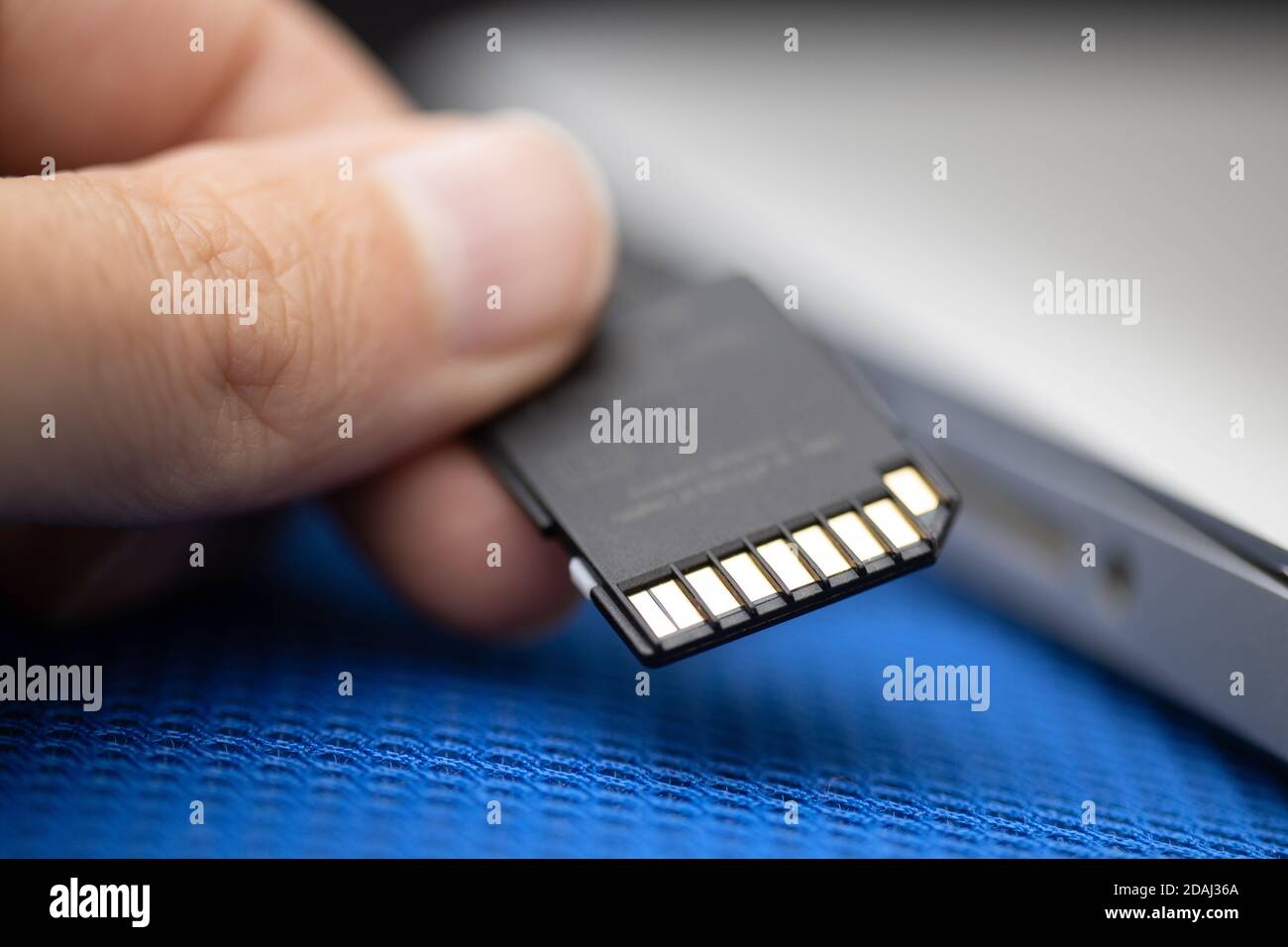 Installing an SD card in a laptop computer. Close up. Concept of