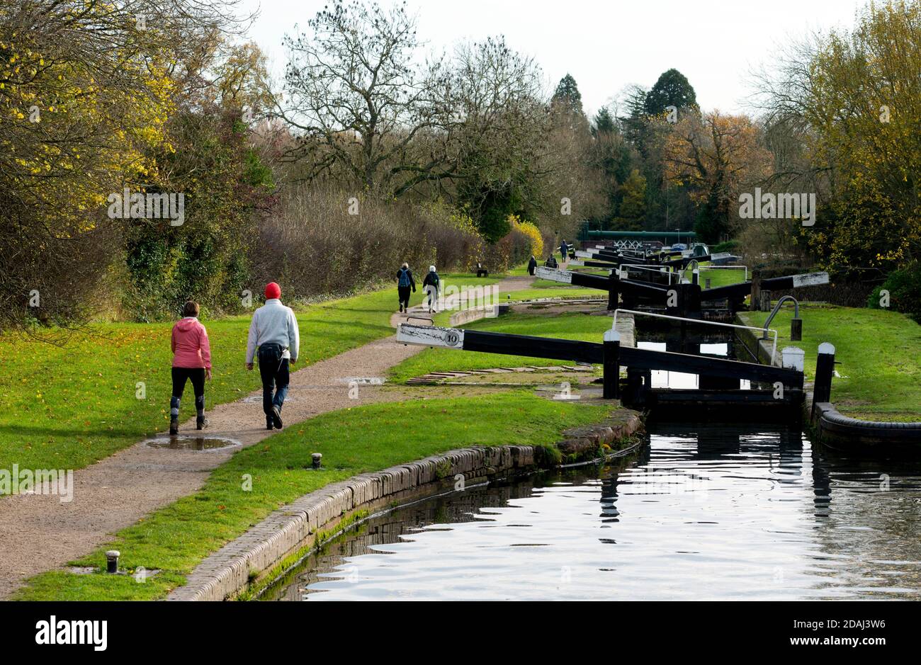 People walking in autumn at Lapworth Locks on the Stratford-upon-Avon Canal, Warwickshire, UK Stock Photo