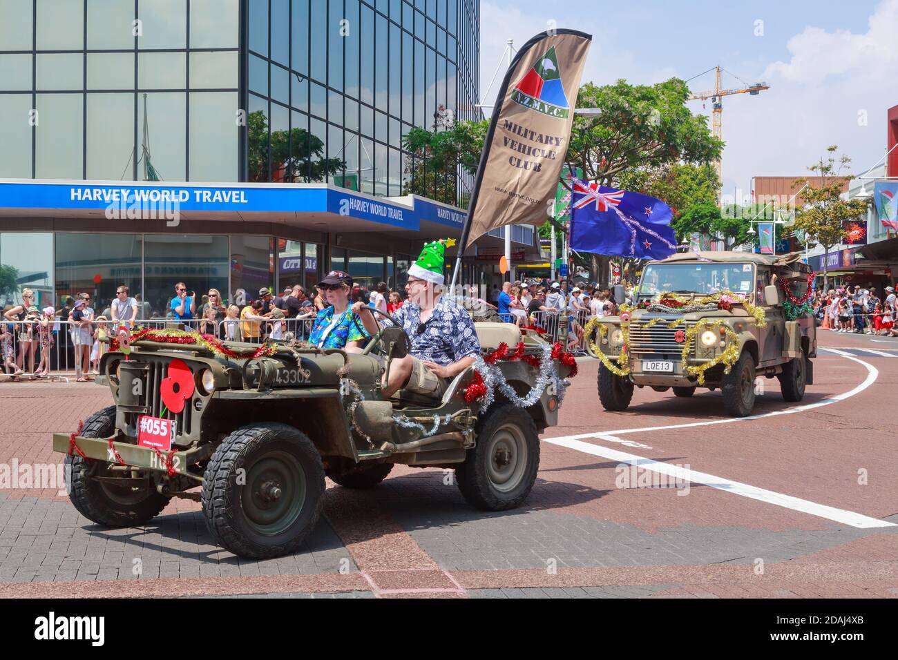 Decorated military vehicles, a jeep and a Land Rover, taking part in a Christmas parade in Tauranga, New Zealand Stock Photo