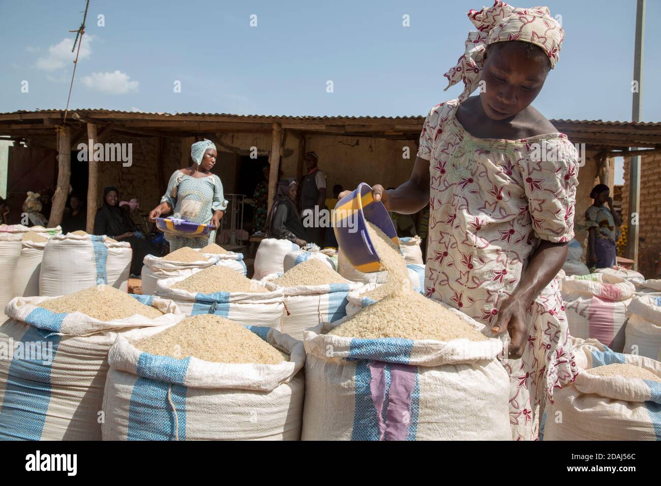 Selingue, Mali, 25th April 2015; preparing sacks of rice on market day. Stock Photo