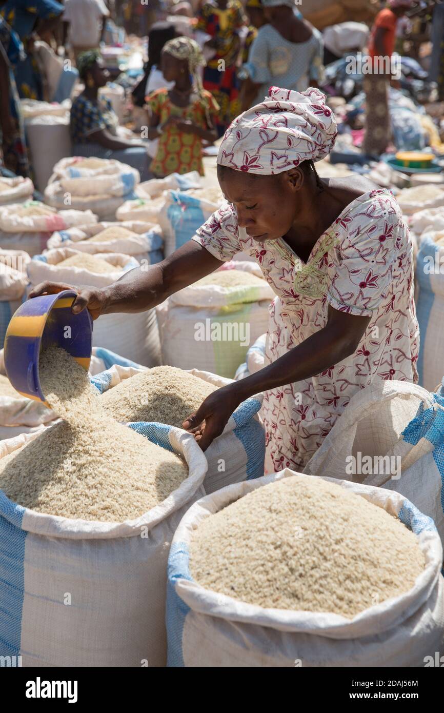 Selingue, Mali, 25th April 2015; preparing sacks of rice on market day. Stock Photo