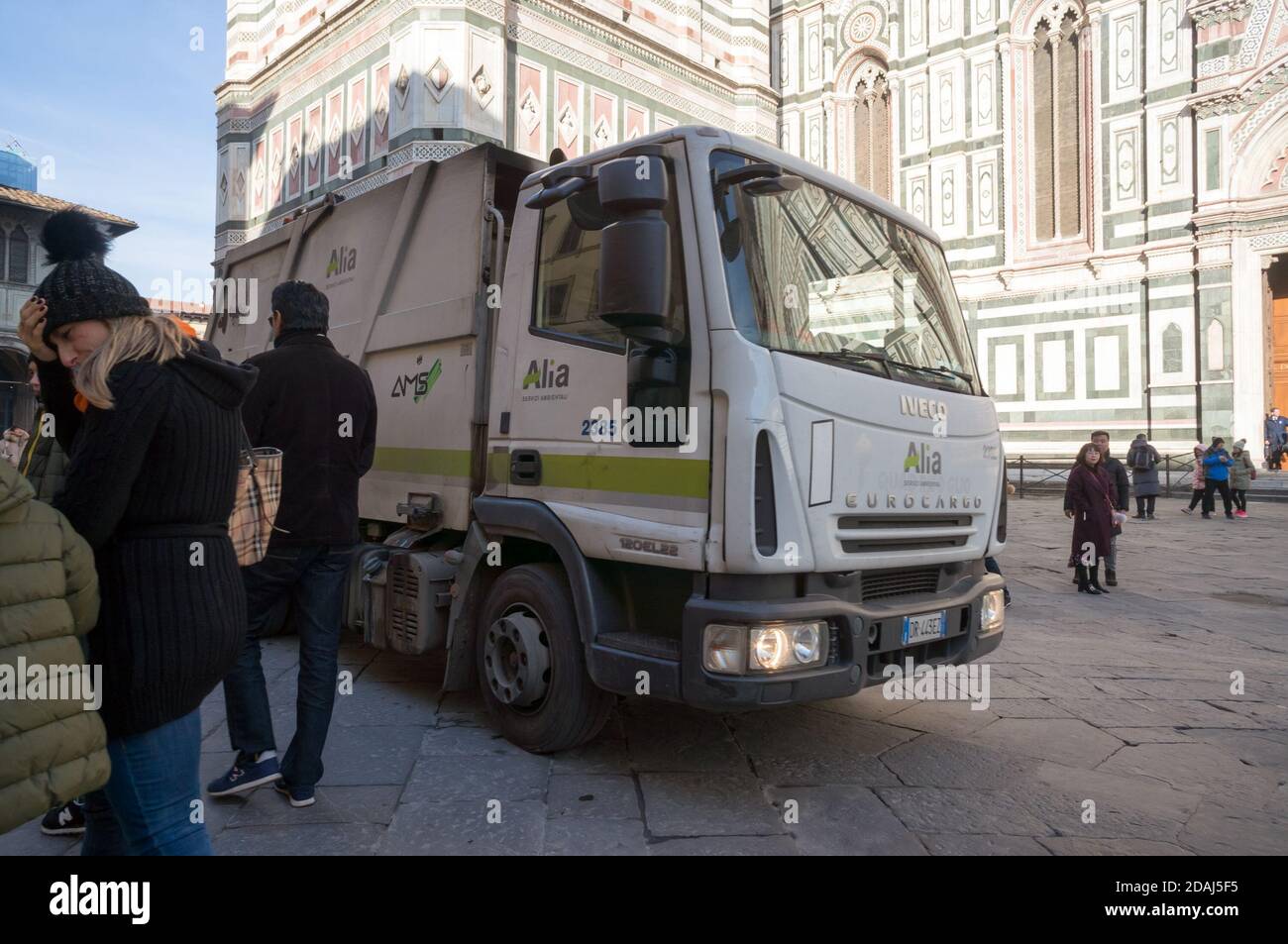 Waste disposal machine rides in front of the baptistery of San Giovanni (1059-1129) on the Cathedral square (Piazza del Duomo). Stock Photo