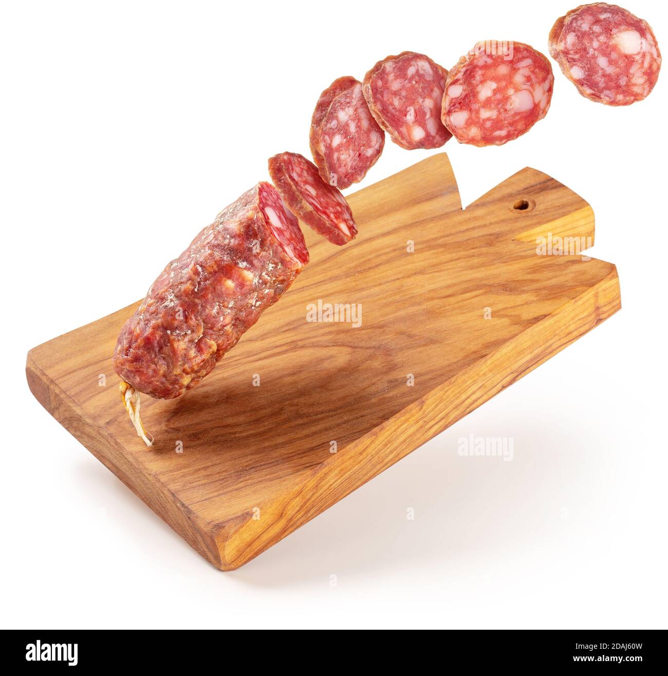 sliced salami flying on a wooden cutting board isolated Stock Photo