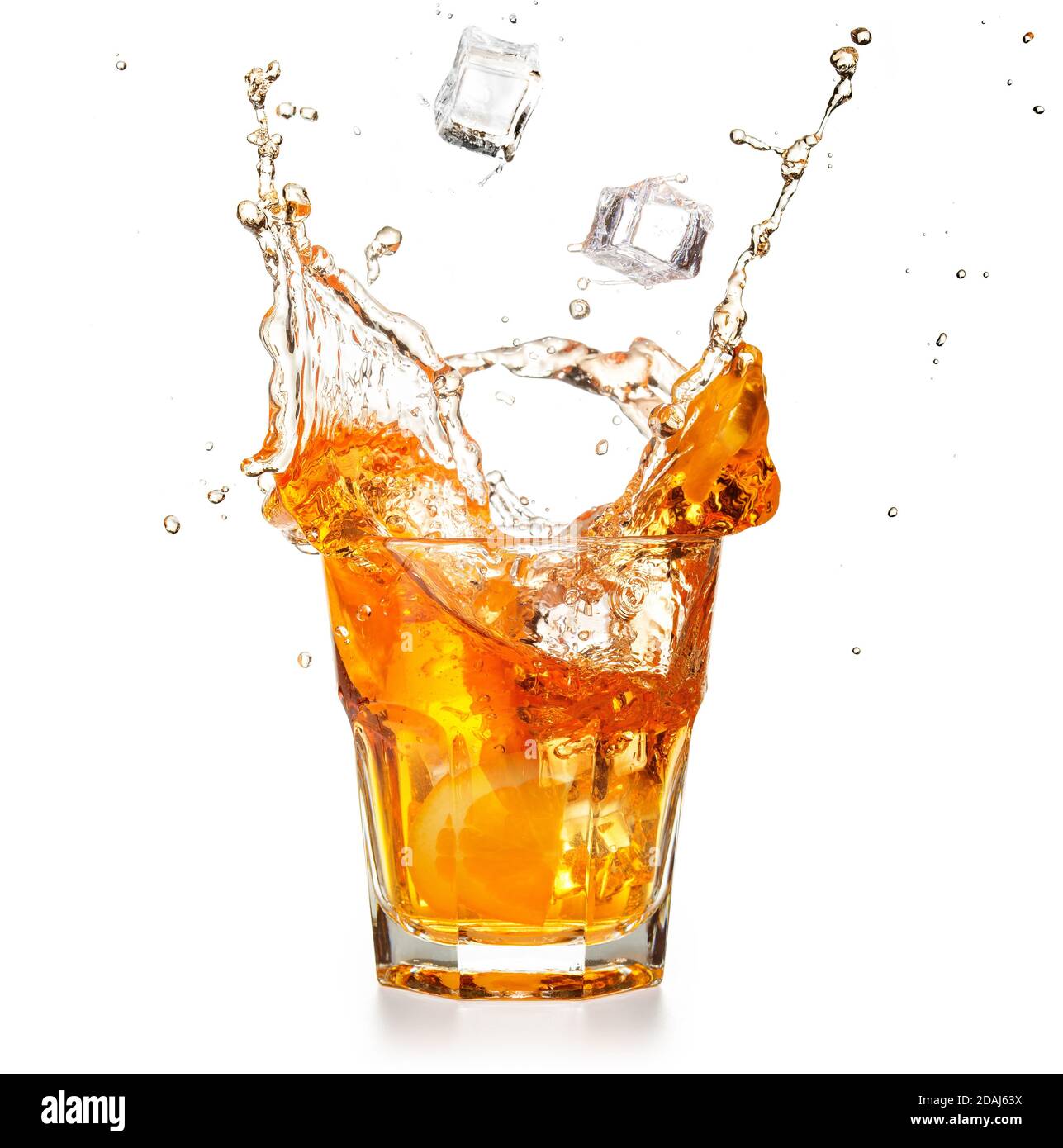 ice cubes falling into a splashing orange cocktail isolated on white Stock Photo