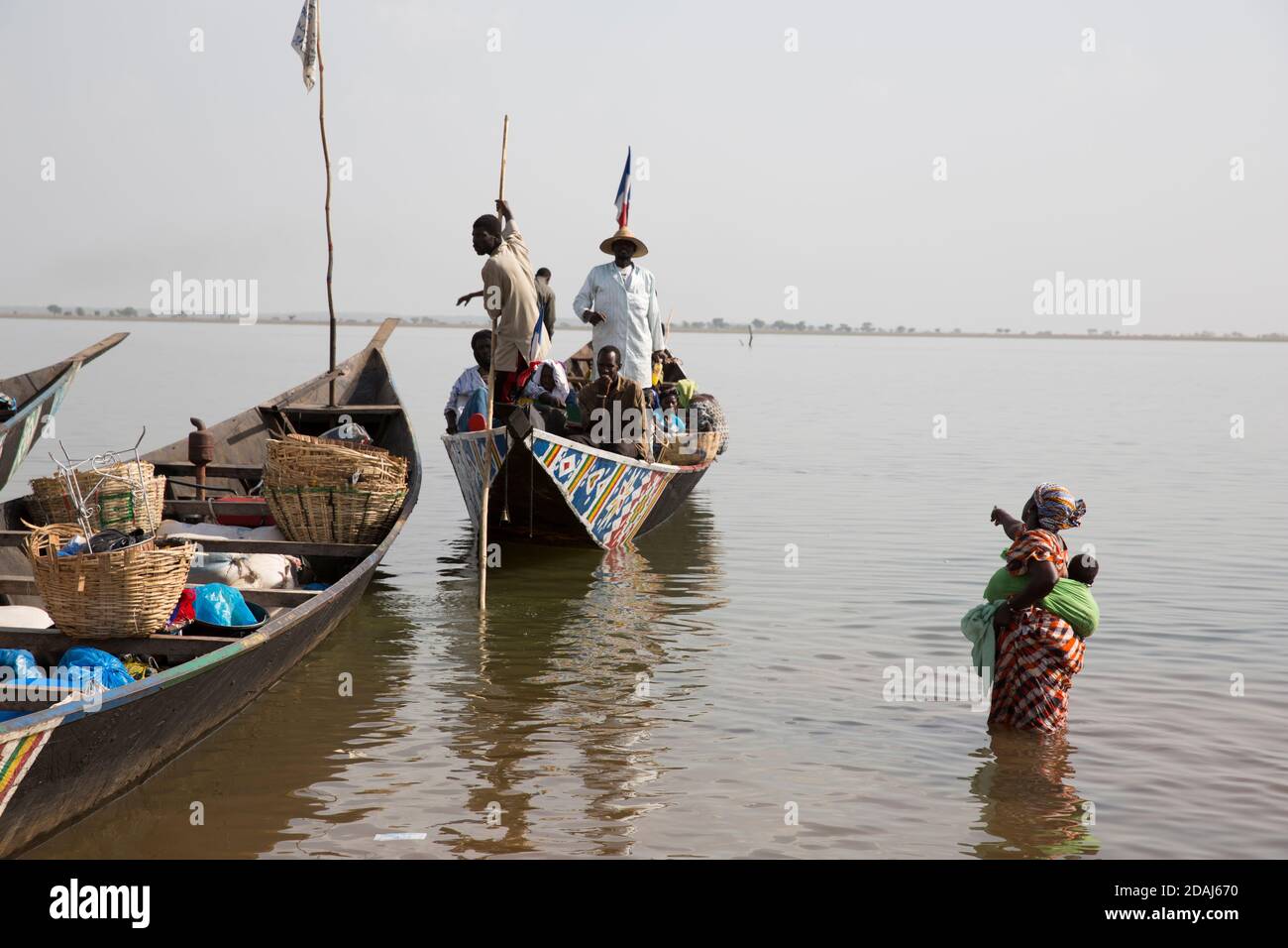 Selingue, Mali, 25th April 2015; Cariere village on the dam lake is a fishing village. Today the boats are carrying people to other villages on the lake such as Sogodogala for market day in Selingue town.  The journey costs 750 CFA per person for a round trip. Stock Photo