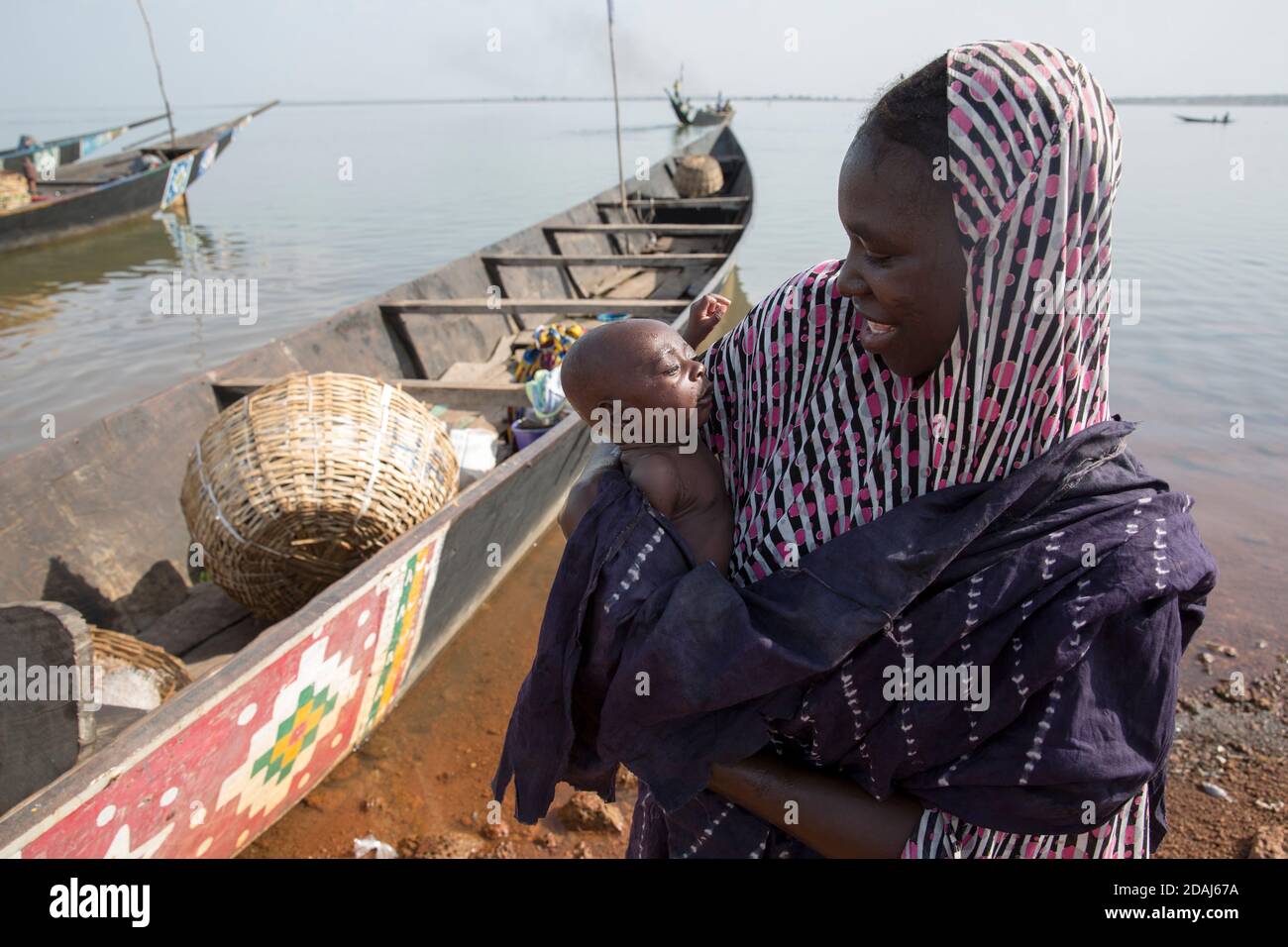 Selingue, Mali, 25th April 2015; Aissata Koita with her baby daughter, who is one month old and not yet named.  She is part of a Bozo family, who typically live by and travel on the river. Stock Photo