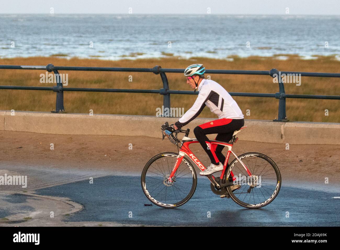 Southport Merseyside UK, 13th November, 2020 Wet cold start to the day ay at the coast as residents of the town take light exercise on the resort seafront promenade. Credit. MWI/AlamyLiveNews.. Stock Photo