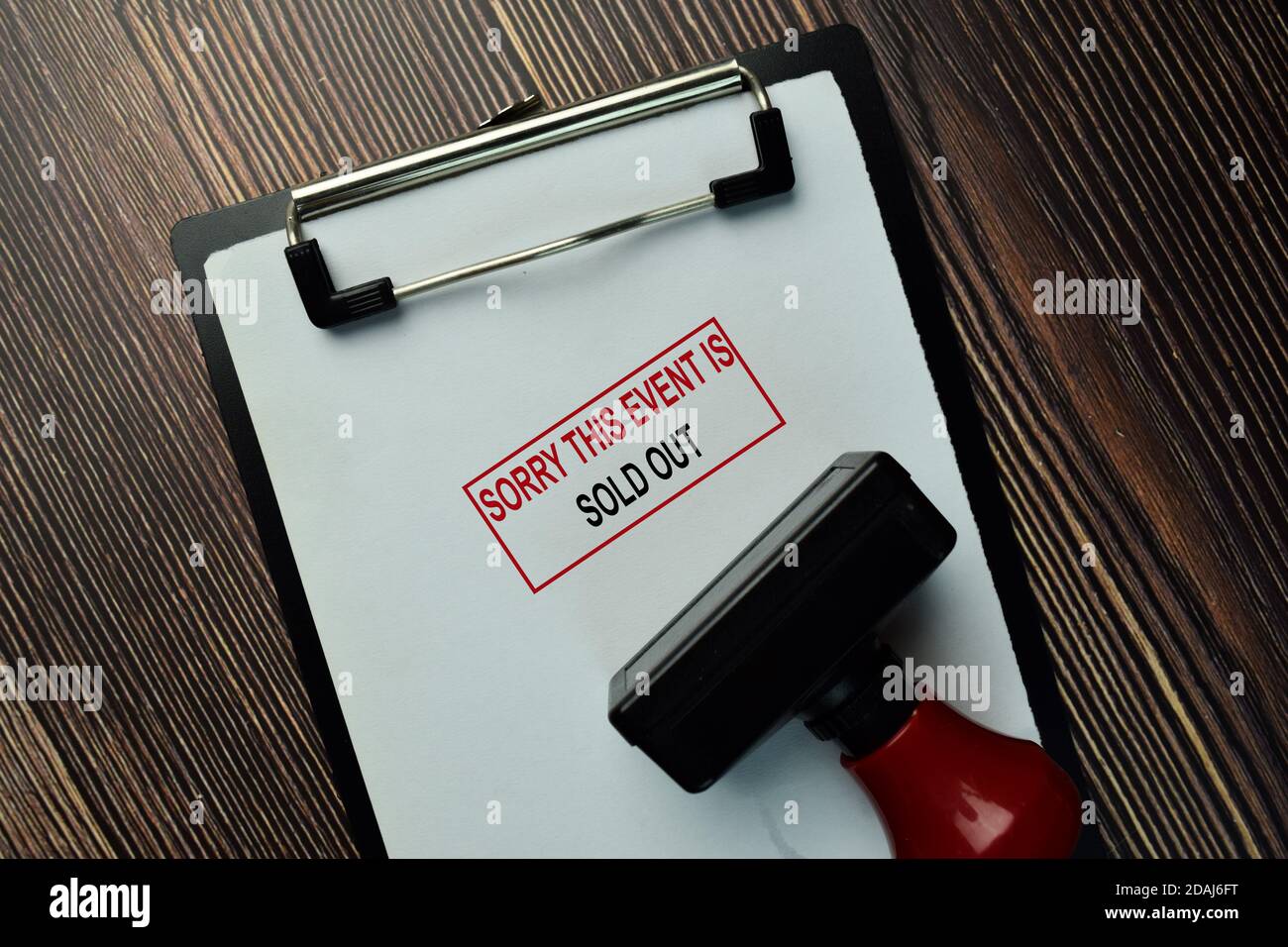 Sorry This Event Is Sold Out write on a book isolated on Wooden Table. Stock Photo