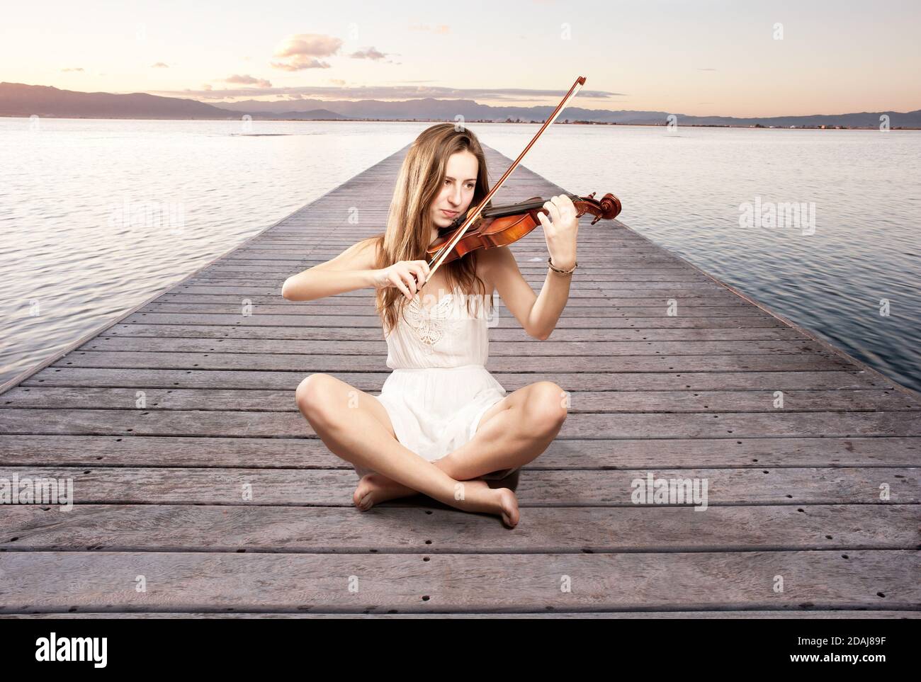 little girl playing violin on a wharf Stock Photo - Alamy