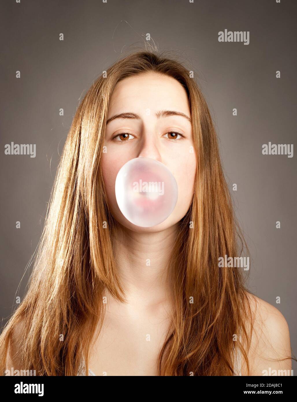 young woman making a bubble from a chewing gum Stock Photo Alamy