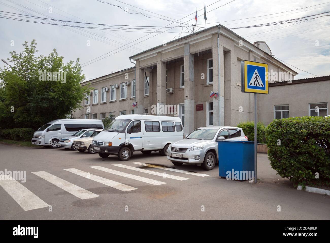 Cars stand in front of the building of the district administration of the Shushenskoye village of Krasnoyarsk Region. Russia. Stock Photo