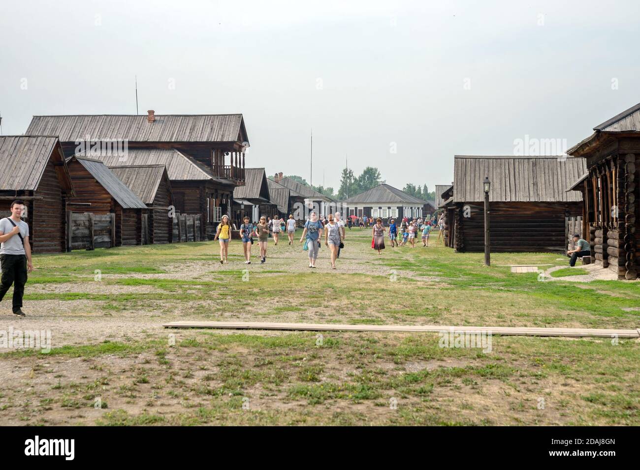 People walk through the historical and ethnographic open-air museum-reserve 'Shushenskoe', formerly the 'Siberian exile of Lenin'. Stock Photo