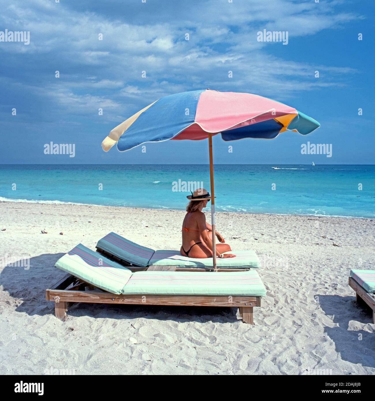 Woman sitting on a sun lounger a parasol, Miami Beach, Miami, Florida, Miami, Florida, USA Stock Photo Alamy