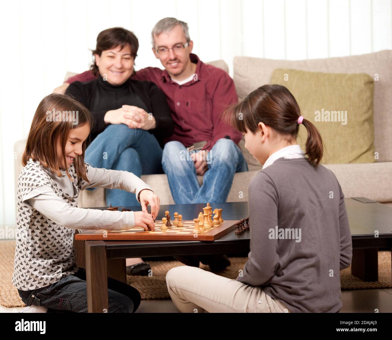 family playing chess at home Stock Photo