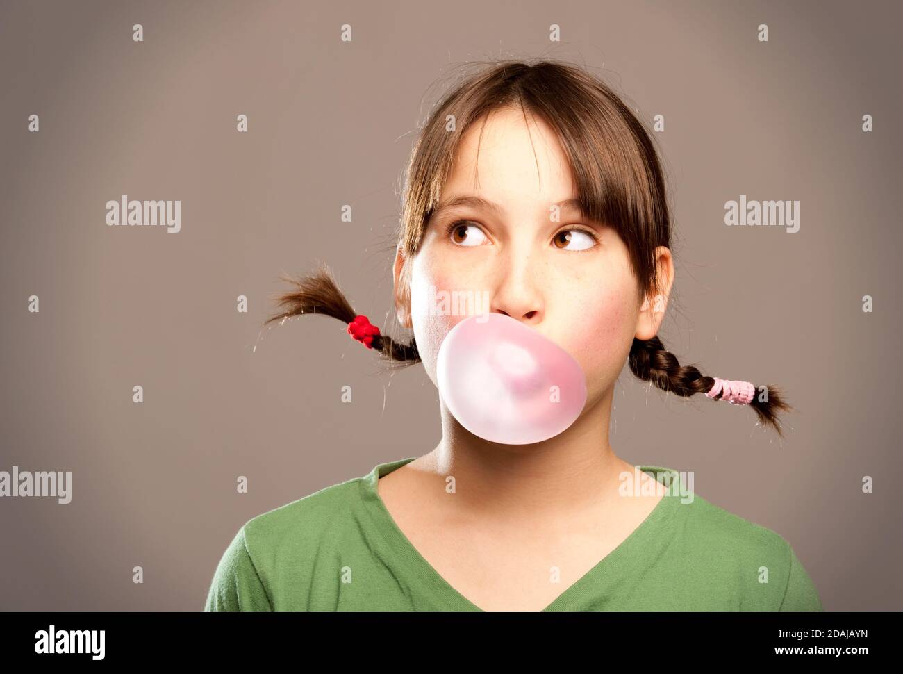 young girl making a bubble from a chewing gum Stock Photo Alamy