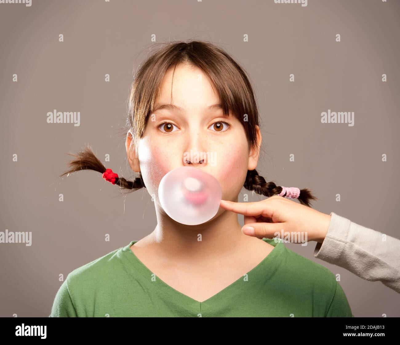 young girl making a bubble from a chewing gum Stock Photo Alamy