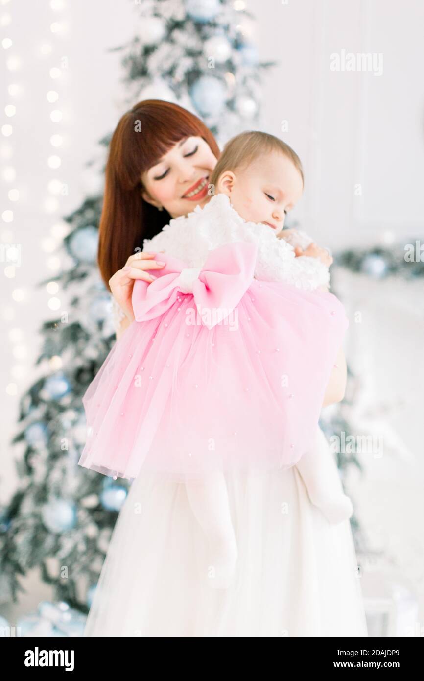 Little baby girl wearing beautiful pink and white dress with big bow on ...