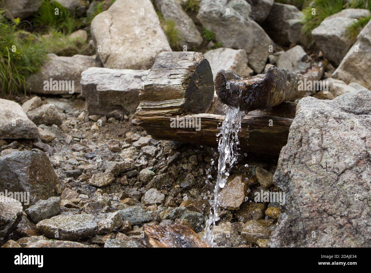 Water spring in the mountains.Source of spring fresh water. Near mount Stock Photo