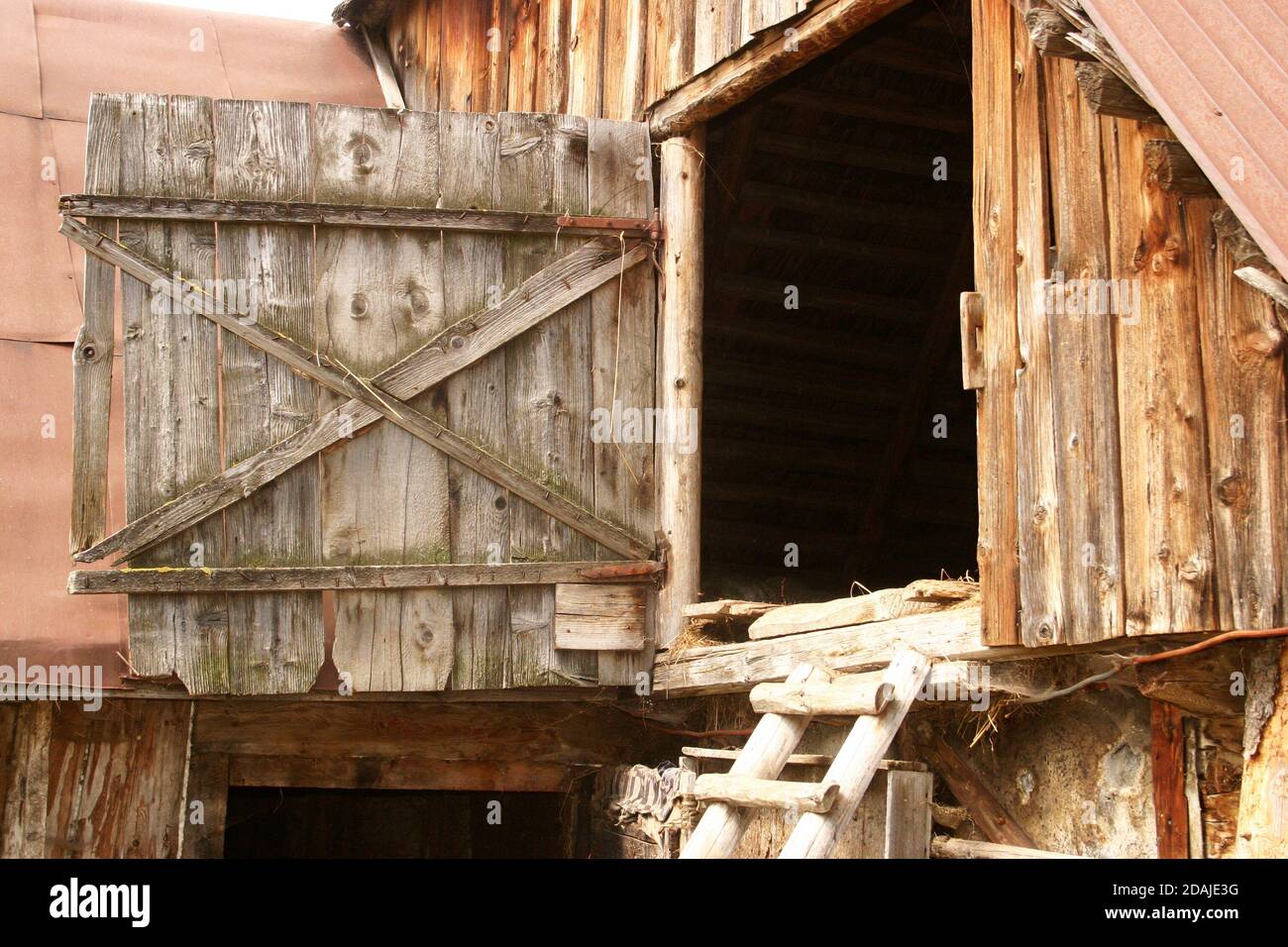 Old wooden barn with hayloft in Brasov County, Romania Stock Photo