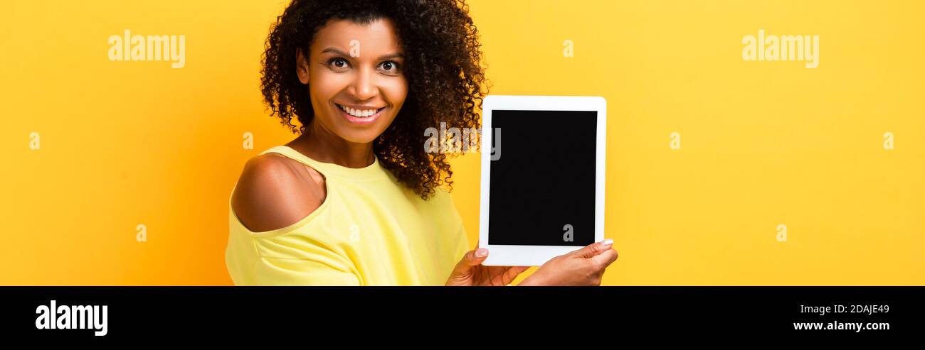 happy african american woman holding digital tablet with blank screen ...